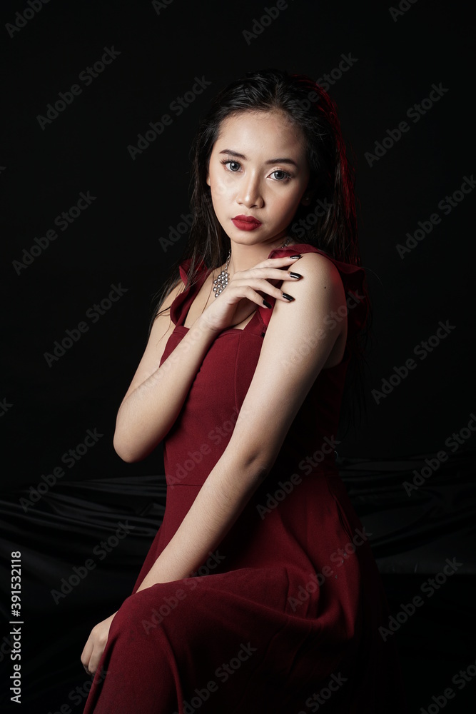 Beautiful girl's face isolated on dark background. Sexy model with sensuality makeup. Glamour fashion model with bright gloss make-up posing at studio. Stylish fashionable concept. Beautiful girl's face isolated on dark background. Sexy model with sensuality makeup. Glamour fashion model with bright gloss make-up posing at studio. Stylish fashionable concept.