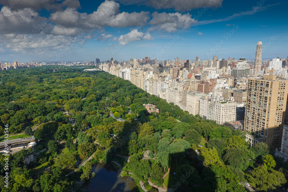 Top view over Central Park in Manhattan during a day with blue sky and white clouds in New York