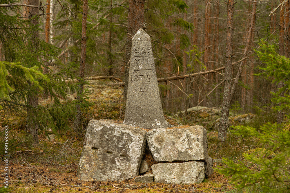 Old milestone along a countryside road in Sweden Old milestone along a countryside road in Sweden