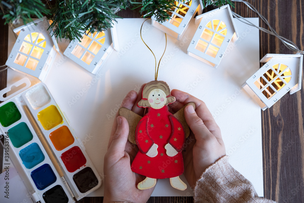 he child paints Christmas decorations / toys for the Christmas tree. New Year's creativity with children, concept