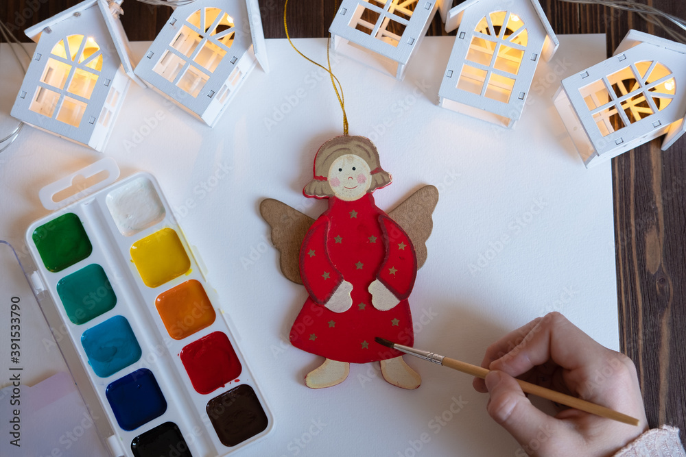 he child paints Christmas decorations / toys for the Christmas tree. New Year's creativity with children, concept