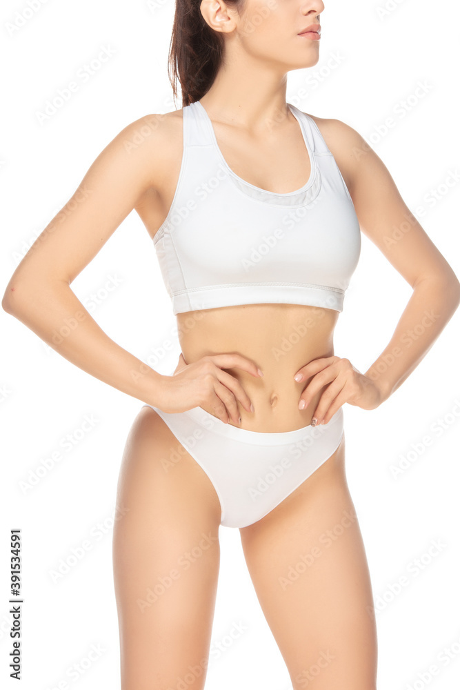 Perfect figure. Beautiful female model on white background. Beauty, cosmetics, spa, depilation, diet and treatment, fitness concept. Fit and sportive, sensual body with well-kept skin in underwear.