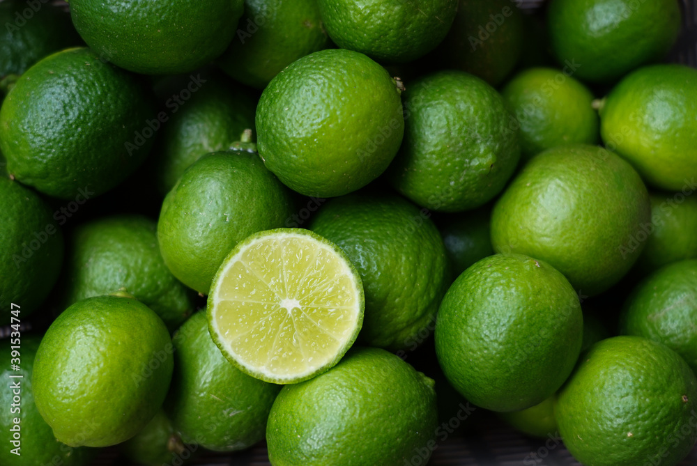 Selective focus at half lime with clusters lime, view from above, placed in a basket Selective focus at half lime with clusters lime, view from above, placed in a basket