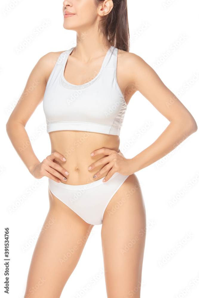Perfect figure. Beautiful female model on white background. Beauty, cosmetics, spa, depilation, diet and treatment, fitness concept. Fit and sportive, sensual body with well-kept skin in underwear. Perfect figure. Beautiful female model on white background. Beauty, cosmetics, spa, depilation, diet and treatment, fitness concept. Fit and sportive, sensual body with well-kept skin in underwear.