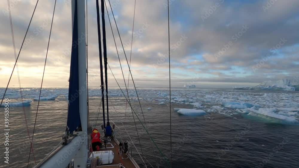 Giant floating Iceberg from melting glacier in Antarctica. View and 4K shooting from a yacht. Nature landscape famous for being heavily affected by global warming. Global Warming and Climate Change. Giant floating Iceberg from melting glacier in Antarctica. View and 4K shooting from a yacht. Nature landscape famous for being heavily affected by global warming. Global Warming and Climate Change.