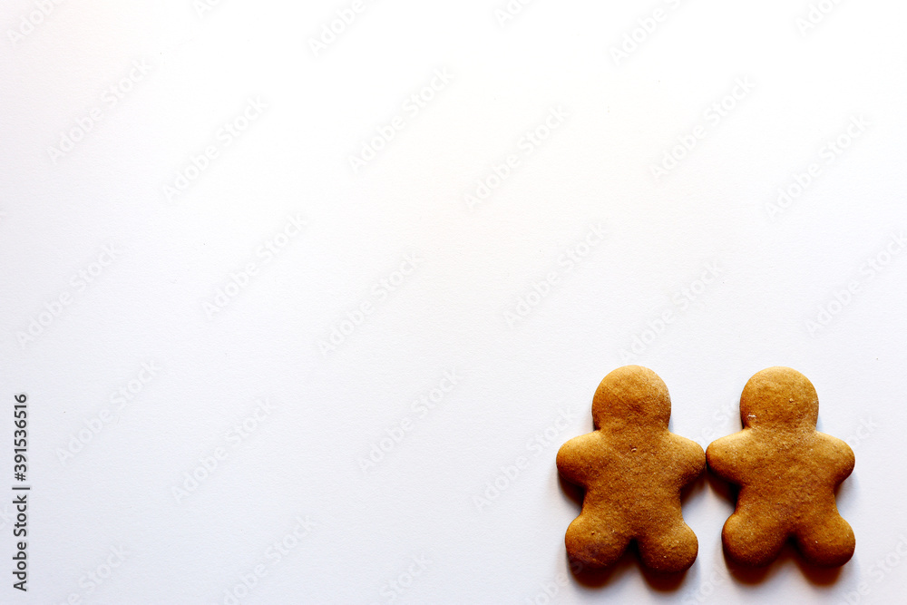 Fototapeta premium Two gingerbread men on a white background