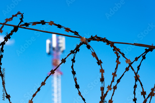 Deny internet. Telecommunication ban concept. Cellular communications are entangled with barbed wire.