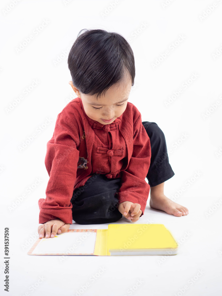 Happy Chinese new year. Asian boy in cheongsam of traditional chinese dress on white background. Happy Chinese new year. Asian boy in cheongsam of traditional chinese dress on white background.