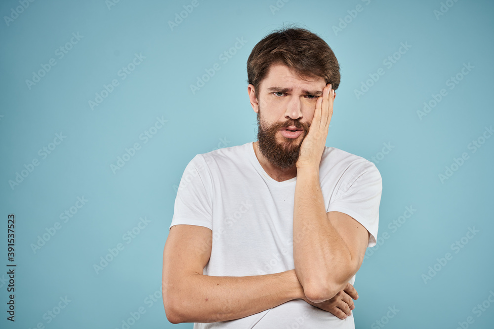 Man in white t-shirt emotions facial expression cropped view studio blue background lifestyle Man in white t-shirt emotions facial expression cropped view studio blue background lifestyle