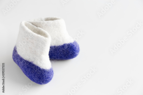 Felt boots on a White background. Finland Independence Day. Card. Copy space.