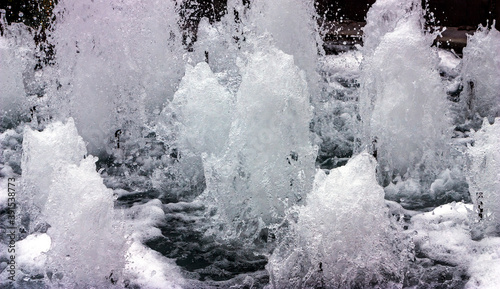 Fountain - water flowing into the water. © Mikhail