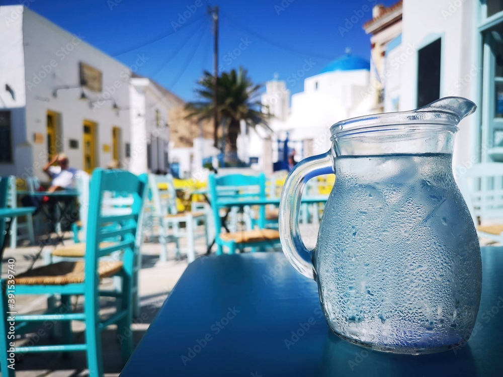 refreshing water in front of a marketplace on the island of Serifos, Greece