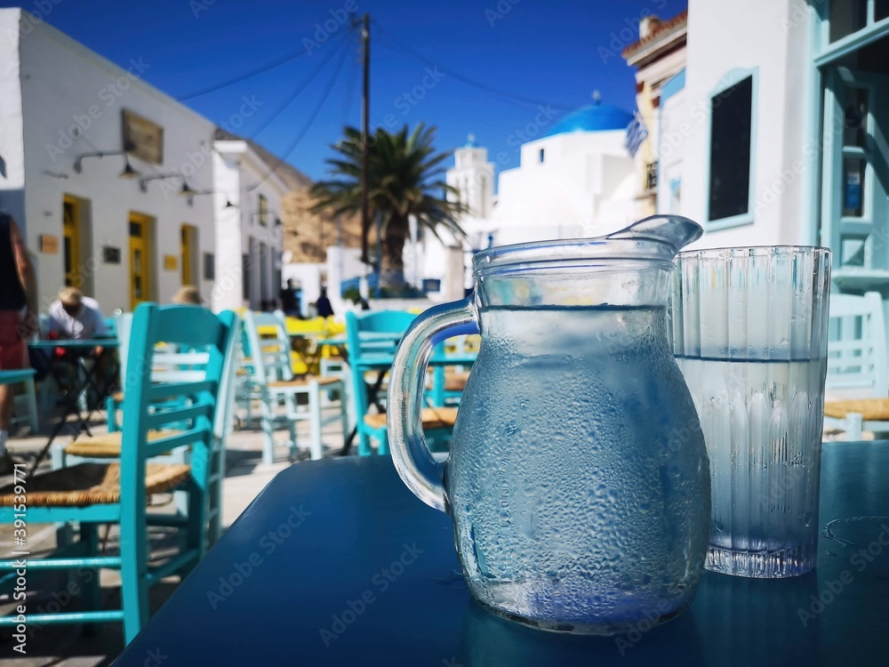 refreshing water in front of a marketplace on the island of Serifos, Greece