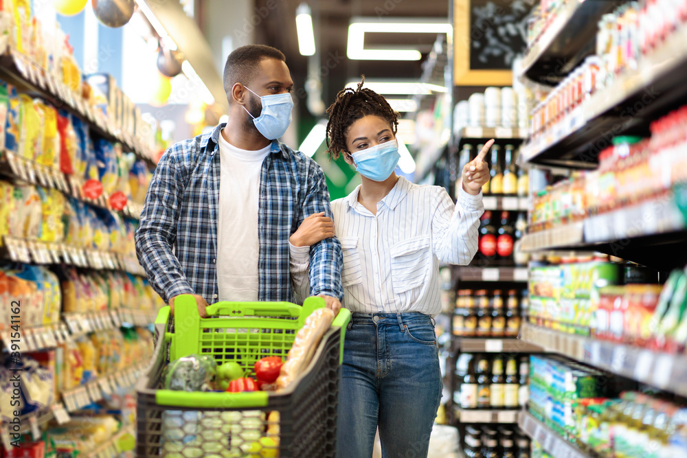 African Couple In Protective Masks In Supermarket Doing Grocery Shopping