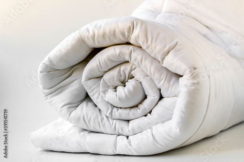 Bilde på lerret Soft,white,washable double size fiber quilt rolled on the white background