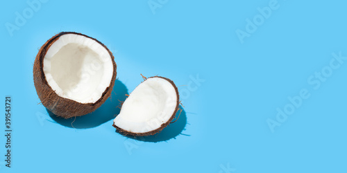 Fresh juicy coconut isolated on a blue background. Concept of Healthy eating and dieting. Travel and holiday concept