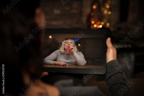 two woman are celebrating holidays while they are social distanced