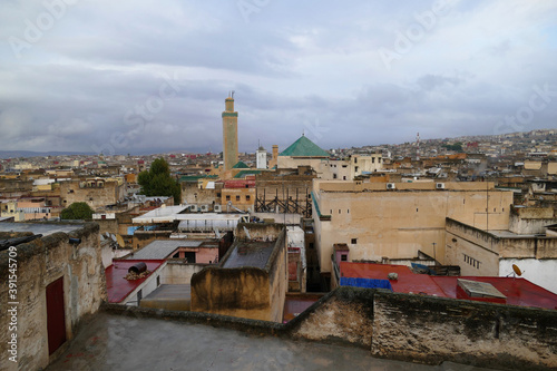 View over the roofs of Fes, Morocco, Africa, with the huge Kairaouine Mosque (Mosque of al-Qarawiyyin) on a rainy day photo