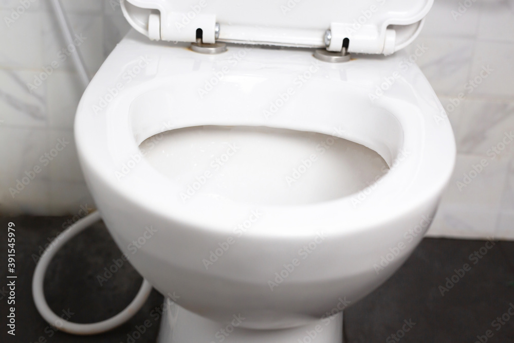 Fototapeta premium Modern bathroom ceramic toilet bowl with black background.