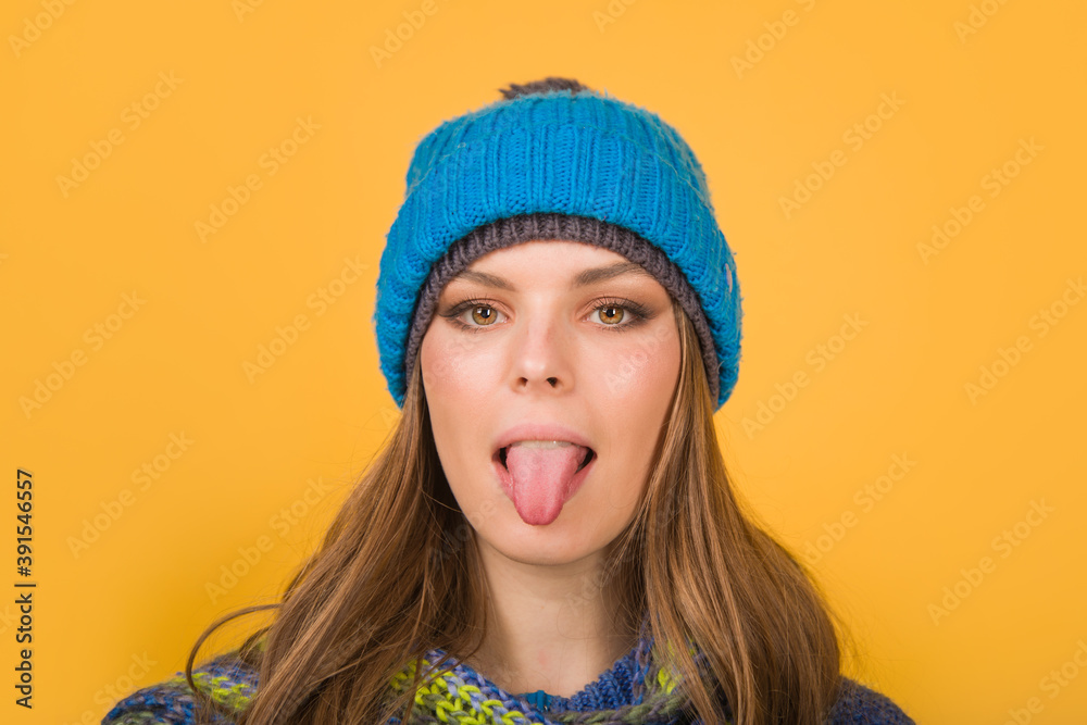 Woman in warm hat shows tongue. Autumn clothes. Winter outfit. Mood. Different emotions. Emoticon set. Feeling and emotions. Face expression. Woman in warm hat shows tongue. Autumn clothes. Winter outfit. Mood. Different emotions. Emoticon set. Feeling and emotions. Face expression.