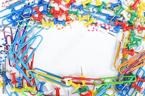 Multicolored paper clips and buttons laid out in a frame