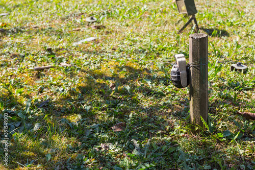 The prohibited antipersonnel mine is placed on the green grass photo