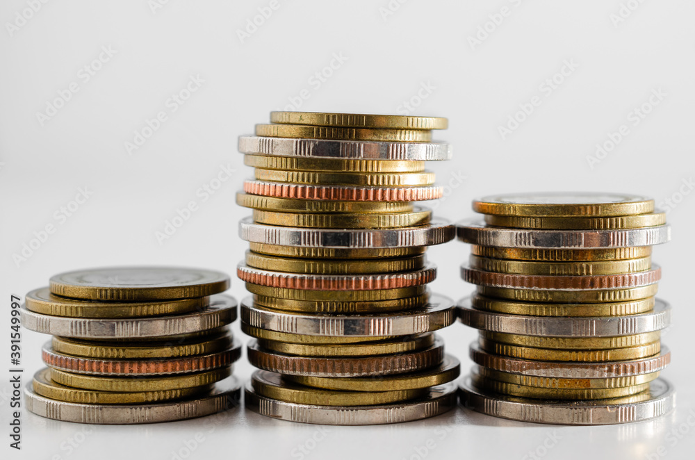 row of coin stack growing pile on white background for money saving and investment business financial and banking concept. row of coin stack growing pile on white background for money saving and investment business financial and banking concept.