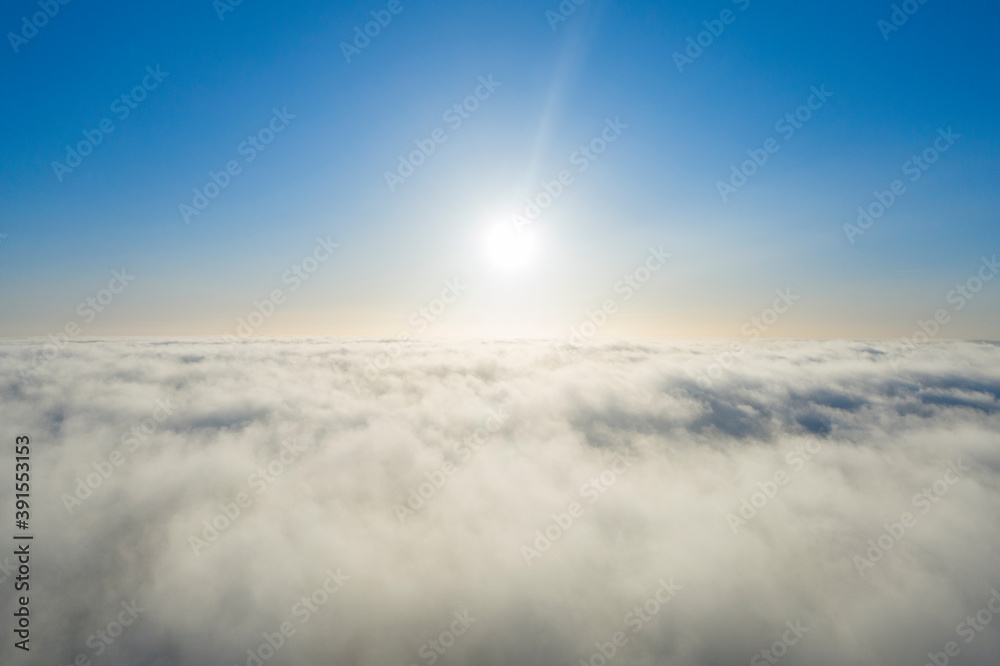 Aerial view white clouds in blue sky. View from drone. Aerial top view cloudscape. Texture of clouds. View from above. Panorama clouds
