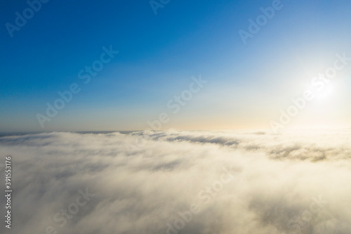 Aerial view white clouds in blue sky. View from drone. Aerial top view cloudscape. Texture of clouds. View from above. Panorama clouds