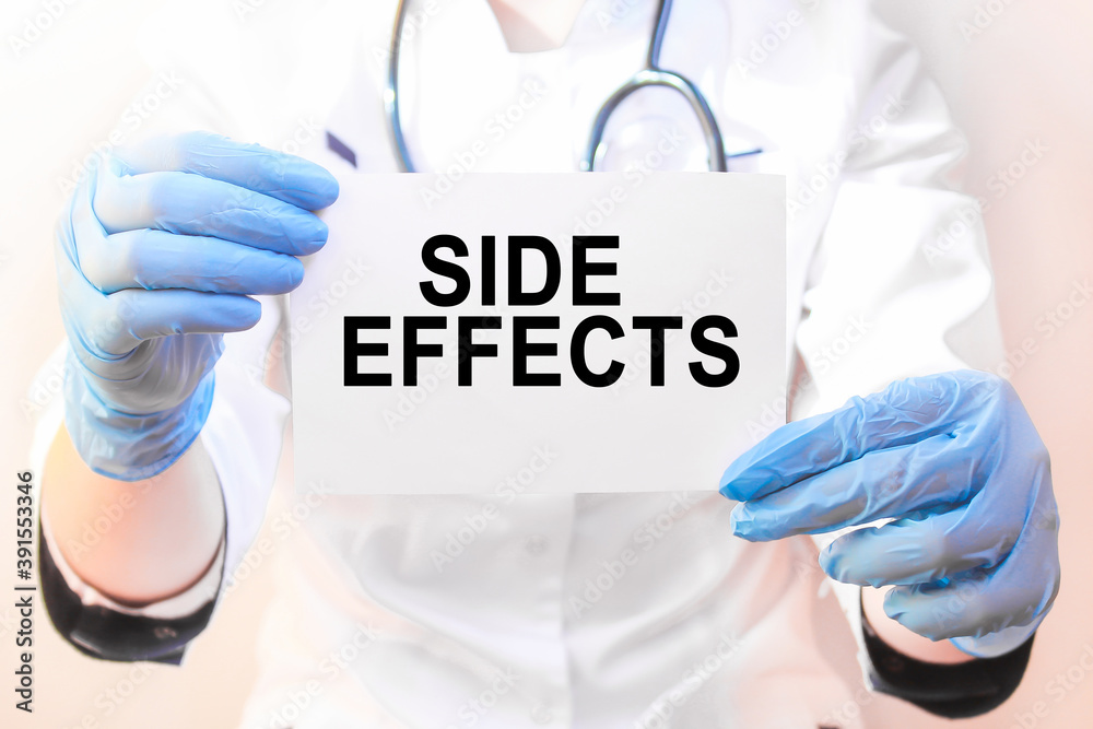 The doctor's blue - gloved hands show the word SIDE EFFECTS - . a gloved hand on a white background. Medical concept. the medicine The doctor's blue - gloved hands show the word SIDE EFFECTS - . a gloved hand on a white background. Medical concept. the medicine