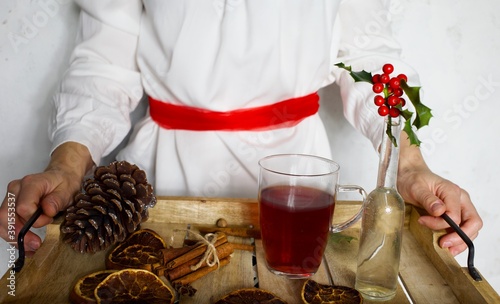 Swedish Sankta Lucia Christmas celebration with woman and tray with mulled wine photo