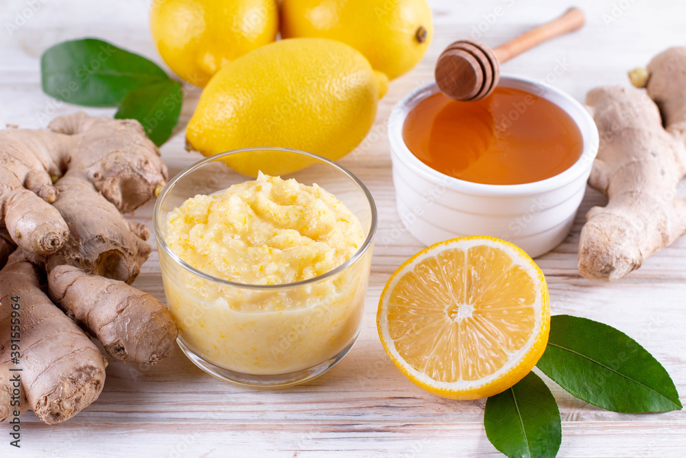 Fall immune system booster - ginger, lemon and honey on a white table Fall immune system booster - ginger, lemon and honey on a white table