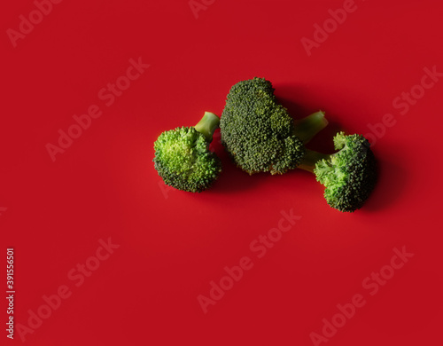 green broccoli on colored background