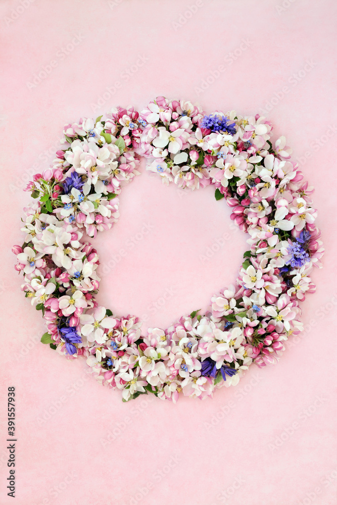 Wreath of spring flowers with apple blossom, bluebells & forget me nots on mottled pink background. Wreath of spring flowers with apple blossom, bluebells & forget me nots on mottled pink background.