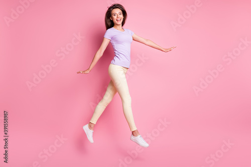 Full length body size view of her she nice-looking attractive lovely glad cheerful cheery slim fit thin girl jumping walking having fun isolated over pink pastel color background