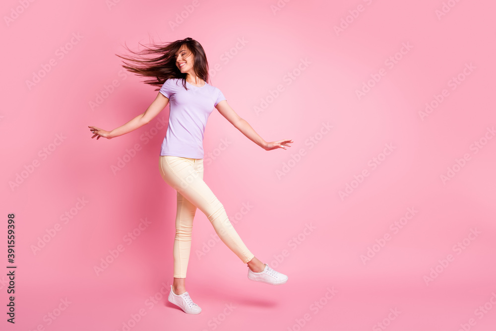 Full size photo of dreamy lady raise hands knee flowing hair dressed purple t-shirt isolated on pink color background