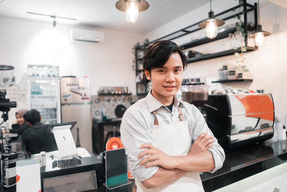 Fototapeta premium asian barista standing when work breaks at house of coffee