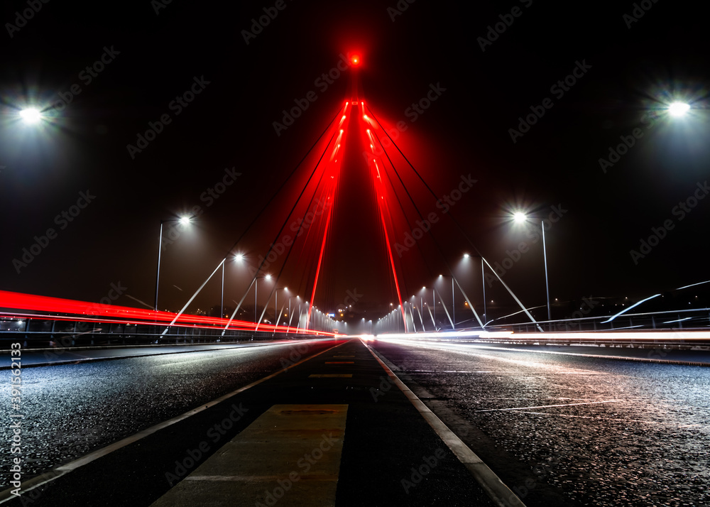 Northern Spire Bridge, Sunderland, UK on a misty night and illuminated to commemorate Remembrance Sunday 2020.