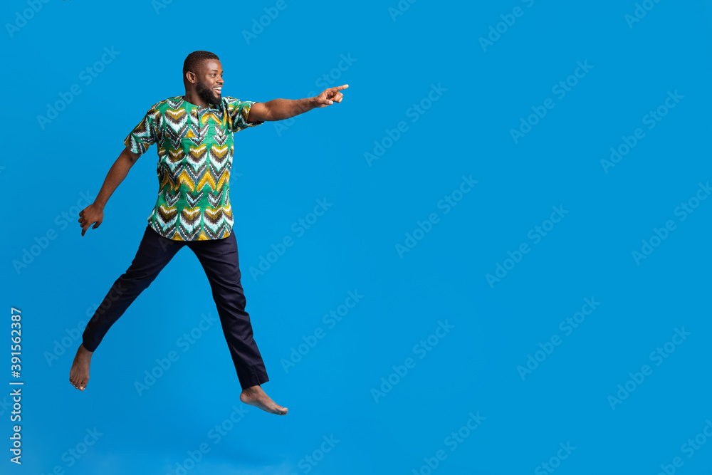 Excited black man running towards copy space for advertisement