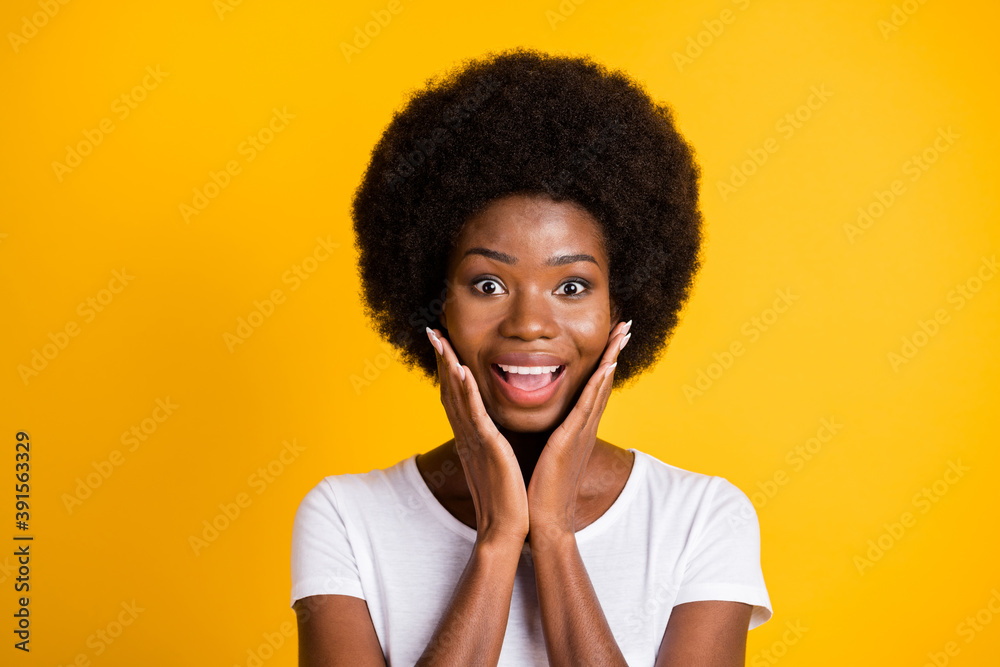 Photo portrait of young surprised woman with perfect skin excited for sales on beauty products holding hands near face with open mouth wearing white t-shirt isolated on vivid yellow colored background Photo portrait of young surprised woman with perfect skin excited for sales on beauty products holding hands near face with open mouth wearing white t-shirt isolated on vivid yellow colored background