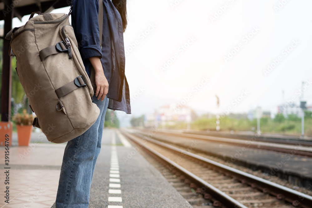 Close up traveler is waiting for train at the railway station. Close up traveler is waiting for train at the railway station.