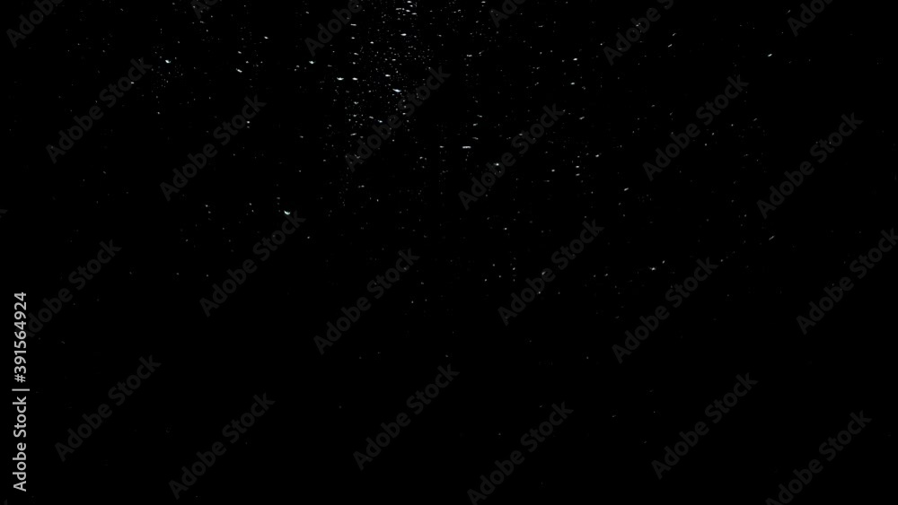 Raindrops on glass against black background
