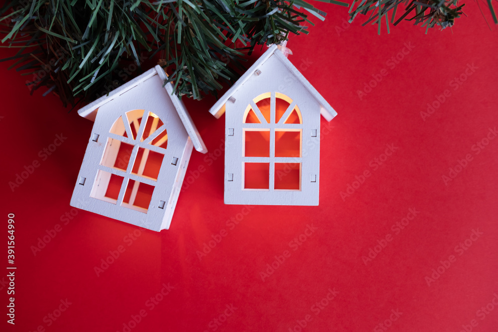 glowing wooden houses garland on the tree. New year and christmas concept, real estate concept