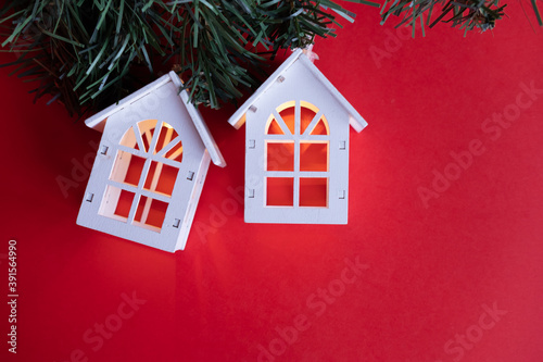 Obraz na płótnie glowing wooden houses garland on the tree. New year and christmas concept, real estate concept w salonie