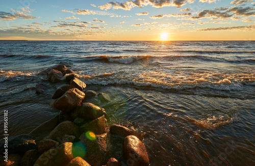 sunset by the bay, stones and waves