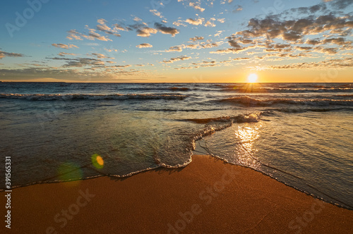 sunset on the sandy beach of the gulf of finland