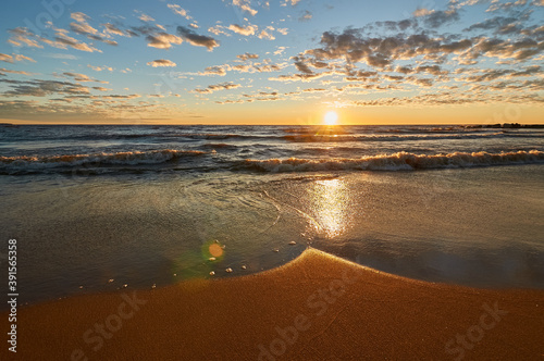 sunset on the sandy beach of the gulf of finland
