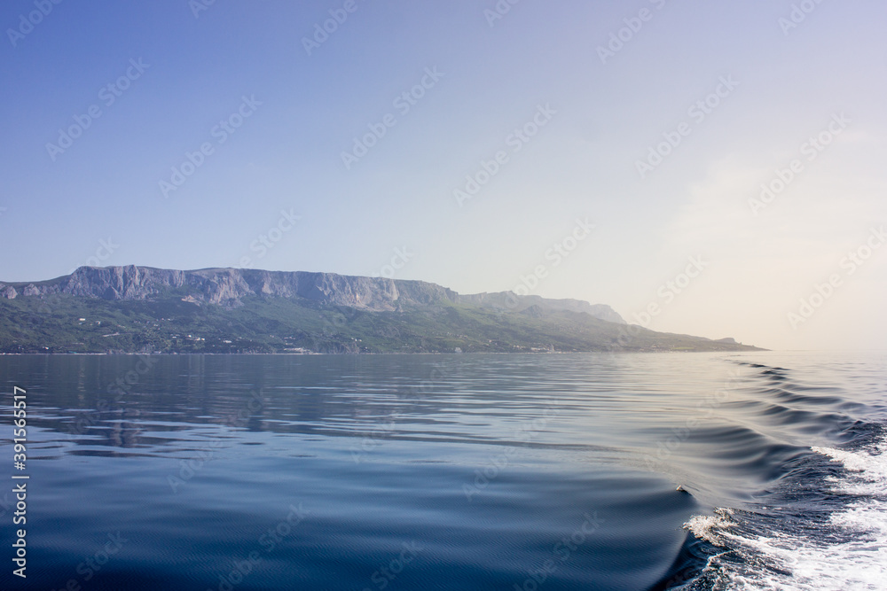 Republic of Crimea, Balaklava city Sea in the morning and mountains illuminated by the sun. Black Sea. Republic of Crimea, Balaklava city Sea in the morning and mountains illuminated by the sun. Black Sea.