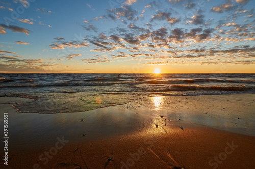 sunset on the sandy beach of the gulf of finland