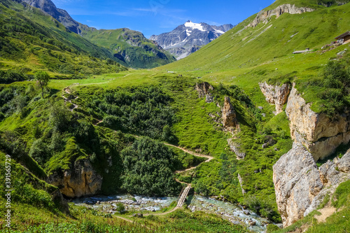 Mountain river and wood bridge in Vanoise national Park valley, French alps photo